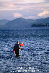 Fly fisherman in waders fishing in Lake George, Adirondack Mountains, New York