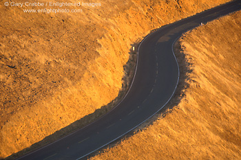 Picture: Two lane twisting asphalt road and golden grass hillside at sunset, Mount Tamalpais, Marin County, California