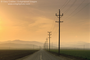 Picture: Sunset over long straight empty road in the Central Valley, Stanislaus County, California