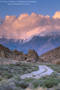 Photo: Alpenglow on clouds at sunset over mountains and dirt road in the Eastern Sierra, California