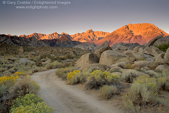 Picture: Dirt road below mountain peaks at sunrise, Eastern Sierra, California