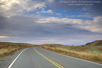 Picture: curving two lane rural country highway road below blue sky and clouds, Glenn County, California