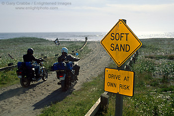 Picture: Soft Sand caution sign next to motorcycles driving onto beach, near Orick, Humboldt County, California