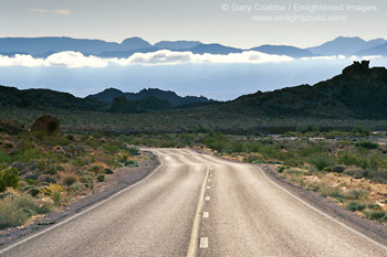 Photo: Two lane desert highway road belwo distand mountain peaks, Valley of Fire State Park, near Lake Mead, Nevada