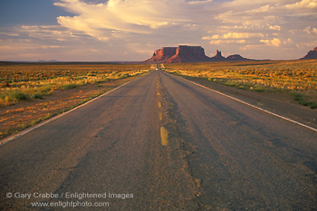 Picture: Long straight endless two lane road through the desert, Monument Valley, Arizona