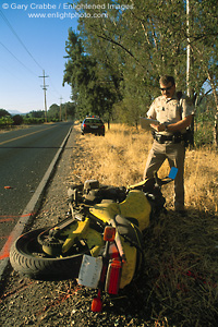 Picture: California Highway Patrol (CHP) Officer investigating solo motorcycle accident along rural country road, Napa County, California