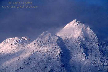 Sunlight shines through a Winter Storm on Black Butte, a volcanic cinder cone, near Mount Shasta, Siskiyou County, Northern California