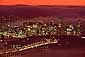 Fog rolling over San Francisco city skyline at sunset behind the Bay Bridge, California