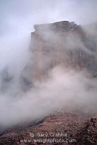 Storm clouds shroud red rock cliffs above Castle Valley, Utah