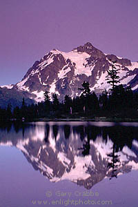 Evening light over Mount Shuksan reflected in alpine lake, Mount Baker National Recreation Area, Cascade Mountain Range, Washington