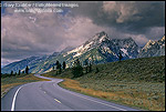 Picture of Curving road below mountain range dusted by first snow of fall, Grand Teton National Park, WYOMING