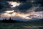 Sunbeams at sunrise through dark storm clouds over the prairie, Grand Teton National Park, Wyoming