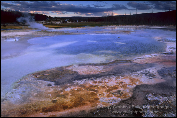 Photo: Mineral deposits at edge of thermal hot spring at sunset, Biscuit Basin, Yellowstone National Park, Wyoming