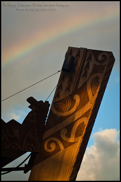 Picture: Rainbow over Polynesian motif wood carving, Paradise Cove, Ko Olina, Oahu, Hawaii