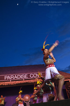 Hula Dancers underneath an evening moon while performing at the Paradise Cove Luau, Ko Olina, Oahu, Hawaii