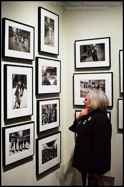 Photo: Woman looking at a photographic art display Photos by Garry Winogrand at the Pier 24 Gallery in San Francisco, California