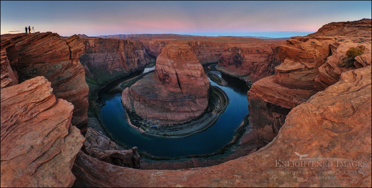 Image: Photographers standing on the rim of Horseshoe Bend at dawn over the Colorado River, near Page, Arizona