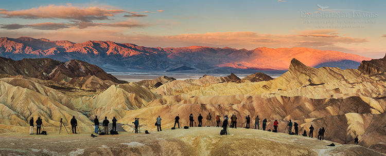 Image: Panoramic photo of photographers lined up to shoot the sunrise at Zabriskie Point, Death Valley National Park, California