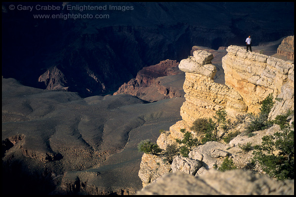 Photo: Dumb tourist standing out on a narrow rock ledge on the rim of the Grand Canyon, Grand Canyon National Park, Arizona