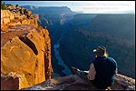 Picture: Tourist enjoying the view over the Colorado River from Toroweap Overlook, North Rim, Grand Canyon National Park, Arizona