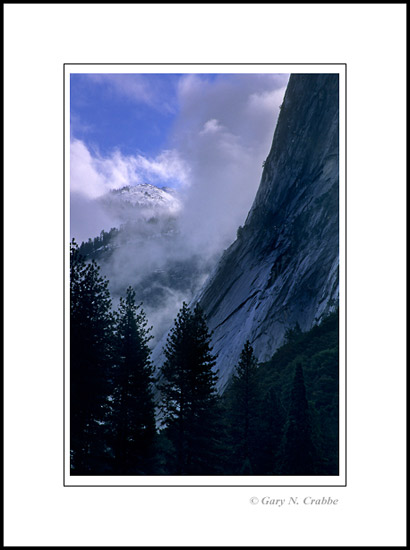 Picture: Winter clouds part over the granite apron of below Glacier Point, Yosemite Valley, Yosemite National Park, California