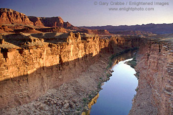 Sunrise light on cliffs above the Colorado River, from Navajo Bridge, Arizona