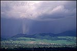 Picture: Sunlit rain burst storm cloud over Walnut Creek and Diablo foothills, Contra Costa County, California