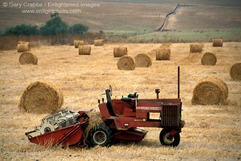 Farm tractor and hay bale rolls in field near Cambria, Central Coast, California; Stock Photo photography picture image photograph fine art decor print wall mural gallery