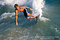 Surfer surfing on breaking wave using a skimboard, near Balboa Pier, Balboa Island, Newport Beach, California