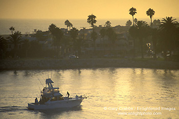 Luxury yacht returning from sea in harbor channel at sunset, Corona del Mar, Newport Beach, California2