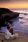 Couple watching the sunset over the Pacific Ocean from coastal bluff at Scripps Park, La Jolla, San Diego County Coast, California