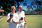 Elderly couple poses holding Bocce Balls at Bocce Ball court in Balboa Park, San Diego, California