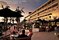 Couple relaxing on patio at sunset, Hotel Del Coronado resort, Coronado Island, San Diego, California