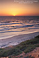 Sunset over beach and Pacific Ocean at Carlsbad, San Diego County Coast, California