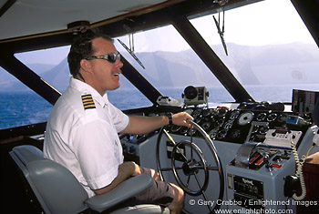 Picture: Captain piloting the Catalina Express Ferry toward  Avalon Harbor, Catalina Island, California