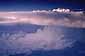 Sunset light on top of cumulonimbus thunderstorm cloud as seen from 35,000 feet