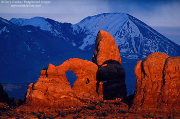 Stormy sunset light on Turret Arch below the LaSal Mountains, Arches National Park, Utah