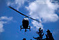 Close up of Helicopter landing under blue sky clouds and trees, near Philo, Mendocino County, California