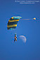 Tandem paraglider in blue sky flying in front of 1st quarter moon, near Tres Pinos, San Benito County, California 