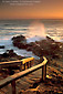 Wooden stairs leading down to coastal rocks and breaking waves at sunset, Leffingwell Landing, Cambria, San Luis Obispo County, central coast, California
