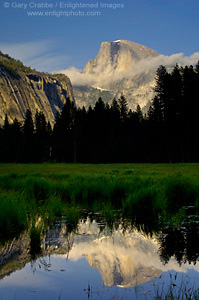 Cloud shrouds Half Dome reflected in spring flood water at sunset, Cooks Meadow, Yosemite Valley, Yosemite National Park, California