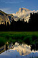 Cloud shrouds Half Dome reflected in spring flood water at sunset, Cooks Meadow, Yosemite Valley, Yosemite National Park, California