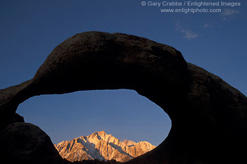 Eroded rock arch over Lone Pine Peak at sunrise, Alabama Hills, Eastern Sierra, California