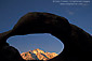 Eroded rock arch over Lone Pine Peak at sunrise, Alabama Hills, Eastern Sierra, California