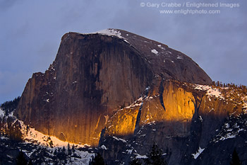 Thin beam of sunset light on Half Dome during a storm, Yosemite Valley, California