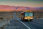 Road to Higher Education school bus on long empty desert road, near Borrego Springs, California