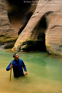 Hiker in the Narrows section of the Virgin River canyon, Zion National Park, Utah