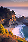 Sunset light on coastal cliffs and waterfall along the Big Sur Coast, Monterey County, California