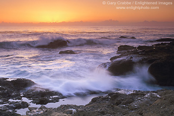 Wave crashing on coastal rocks at sunset, Point Lobos, Monterey County, California