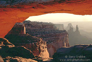 Sunrise light on Mesa Arch and red cliffs of Canyonlands National Park, Utah
